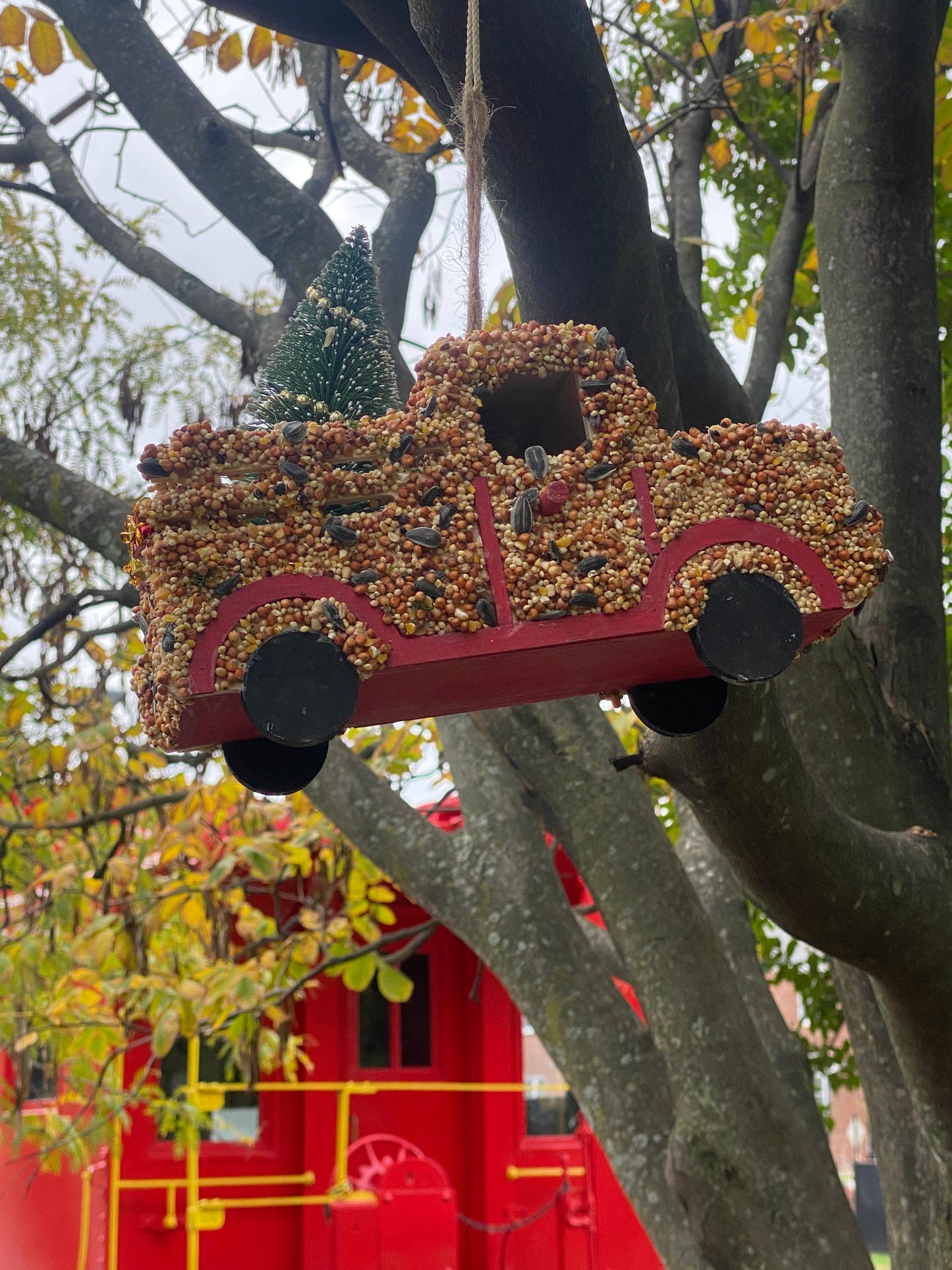 A Red Pick Up Truck with 🎄 Christmas Tree and Presents 🎁